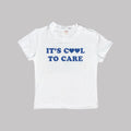 White baby crop tee with 'It's Cool to Care' heart slogan on front