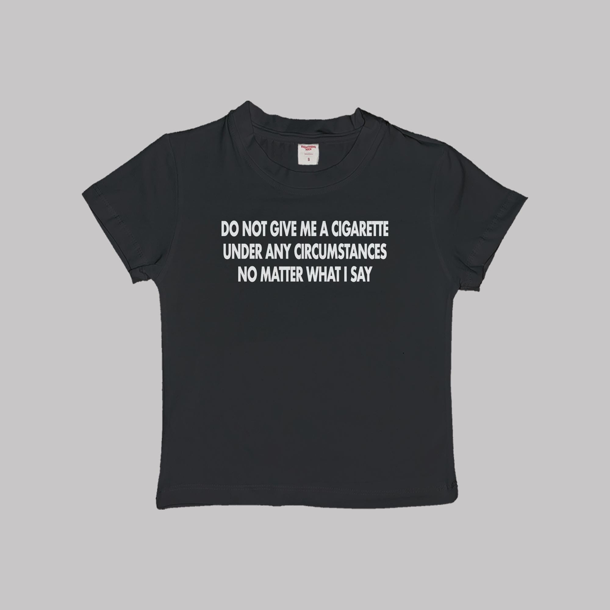 Black short-sleeve baby tee with centered white slogan text