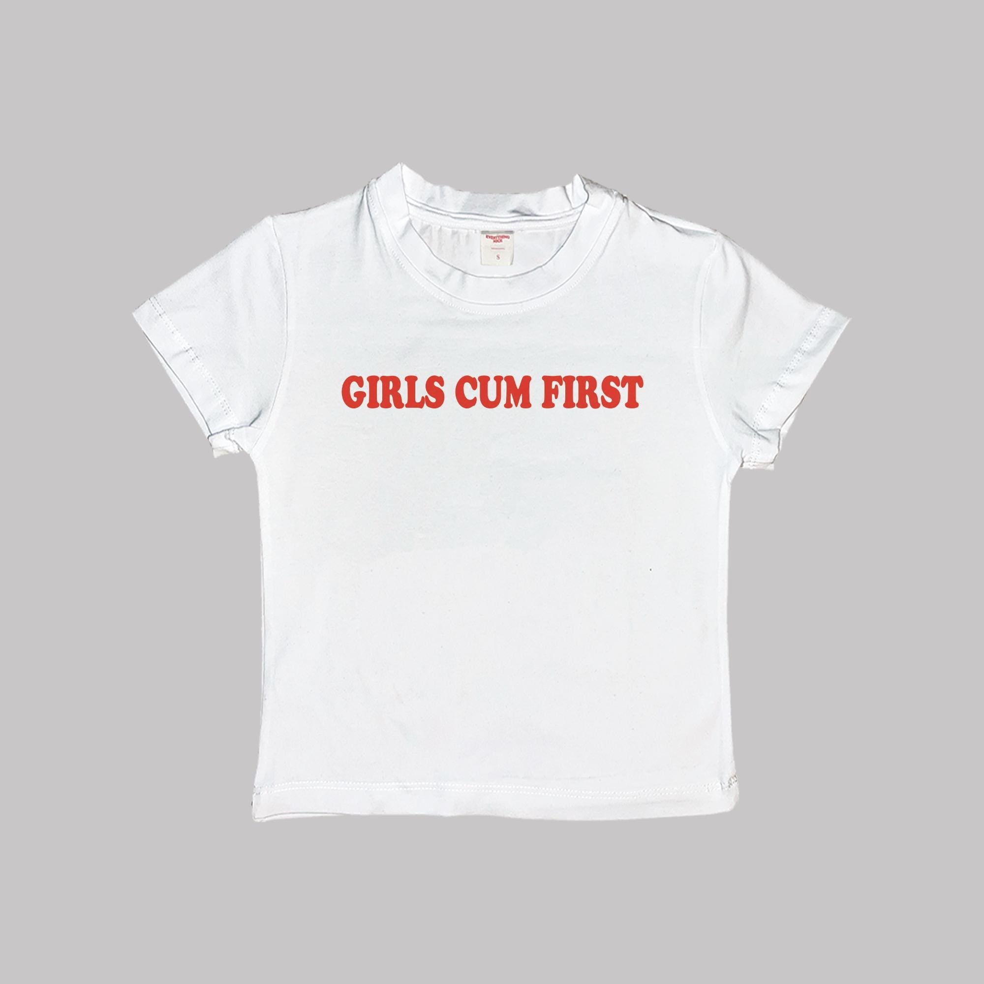 White girls baby tee crop top with red “GIRLS CUM FIRST” text, short sleeves