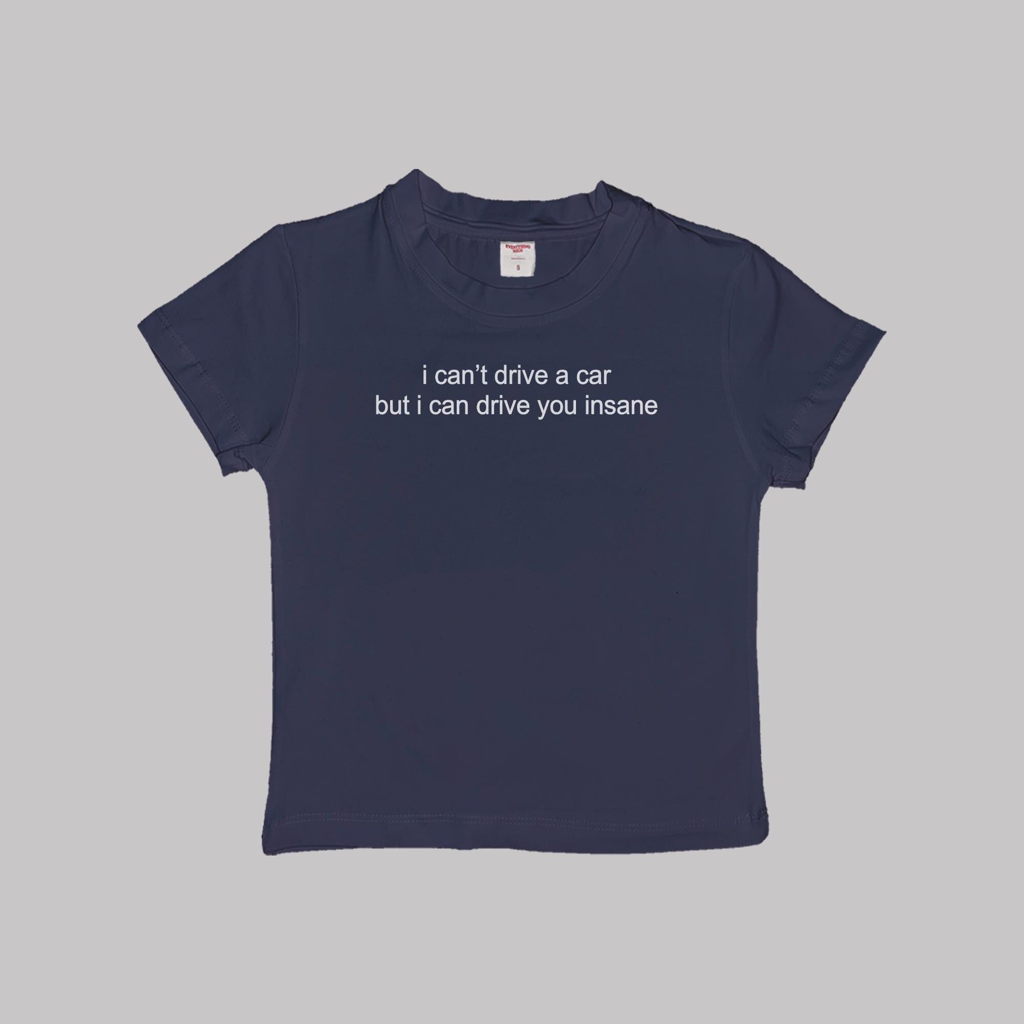 Navy crop baby tee with white slogan text on the front