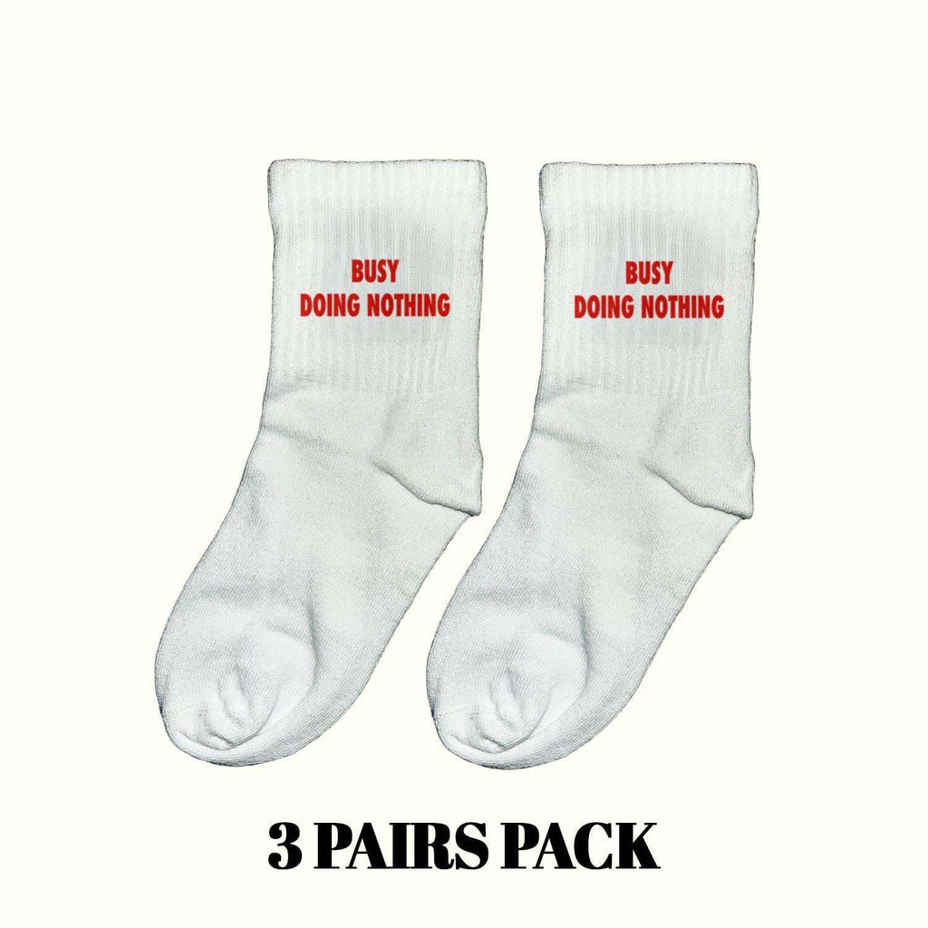 Light gray crew socks with red "Busy Doing Nothing" text