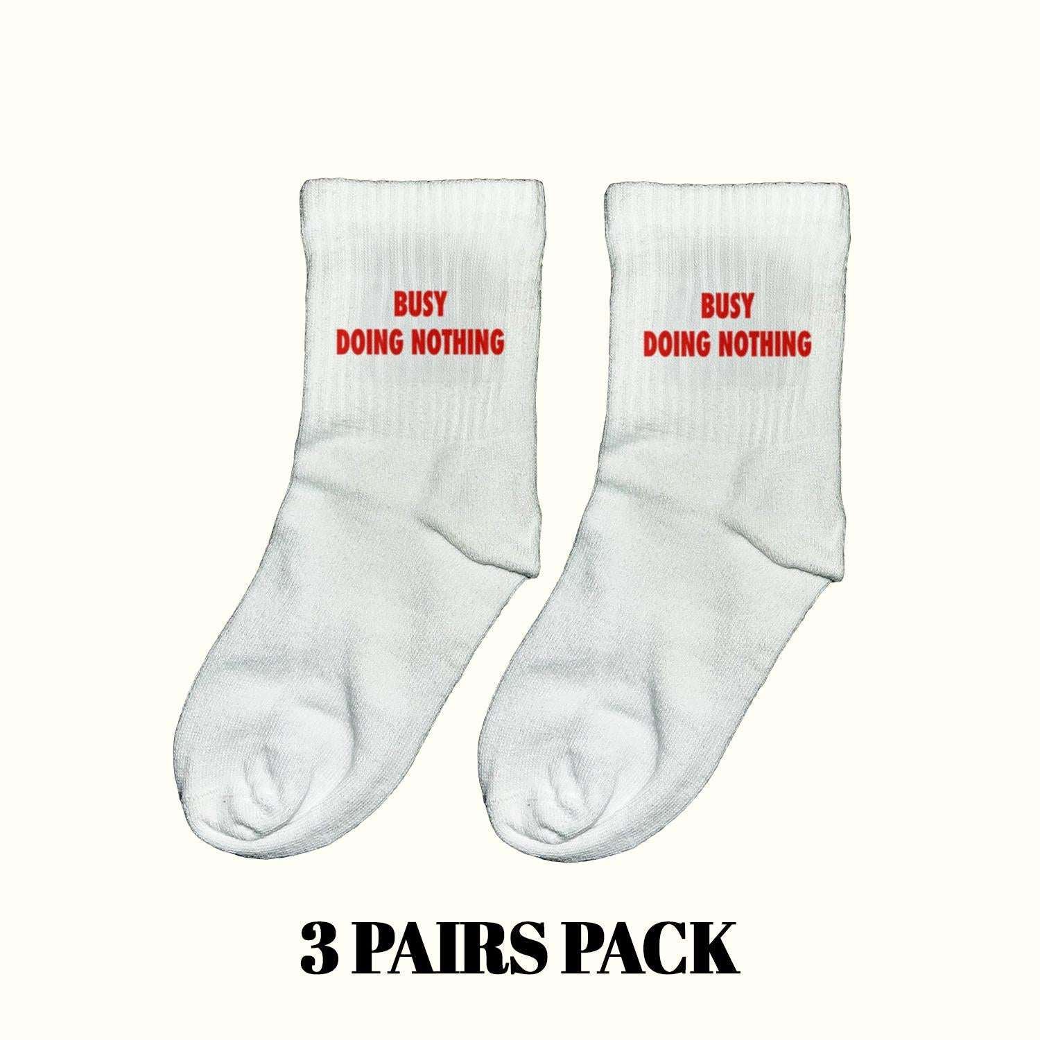 Light gray crew socks with red "Busy Doing Nothing" text