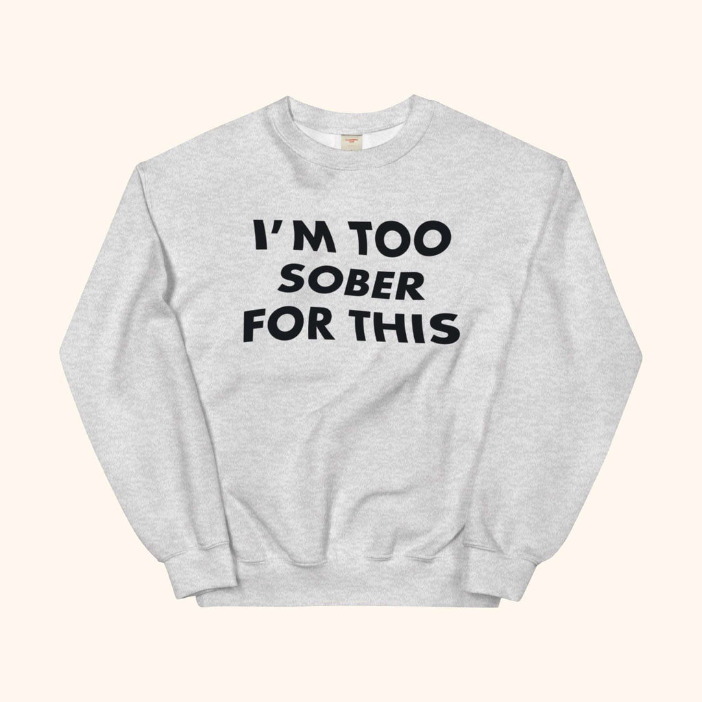 Gray crewneck sweatshirt with bold black slogan graphic on the front