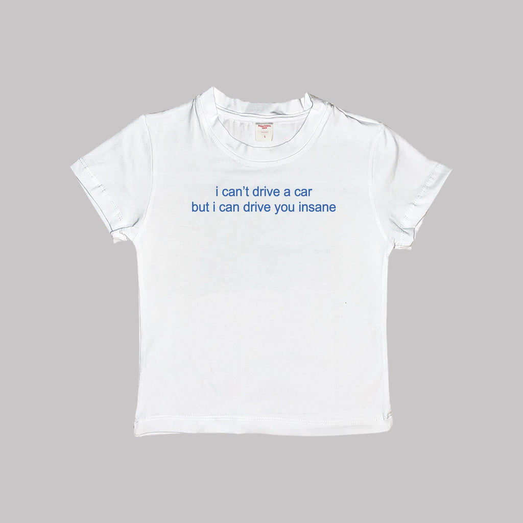 White short-sleeve crop tee with “i can’t drive a car but i can drive you insane” print