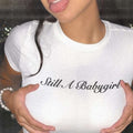 White baby tee crop top with black 'Still A Babygirl' script print