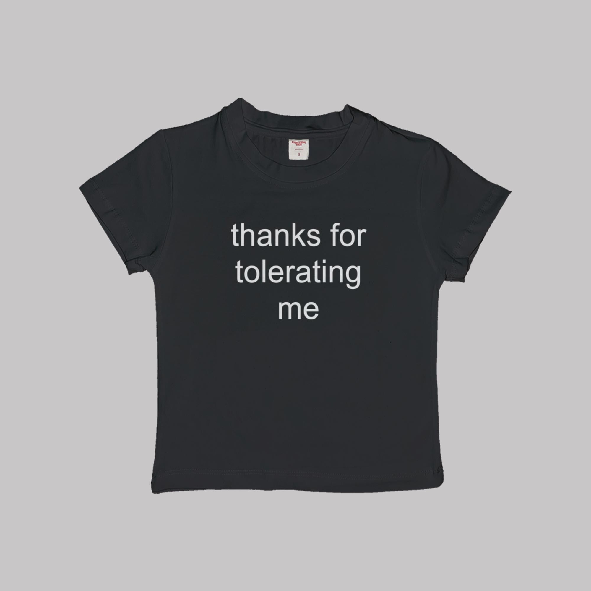 Black cropped baby tee with 'thanks for tolerating me' white text