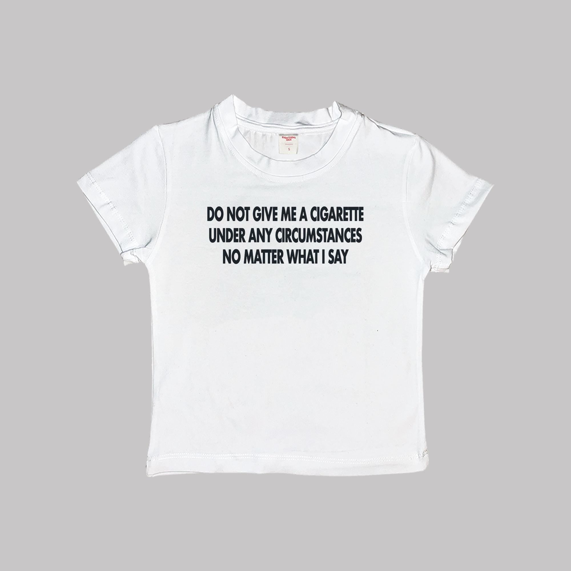 White short-sleeve baby tee with black slogan print