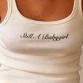 White ribbed muscle tank top with 'Still A Babygirl' logo print, scoop neck