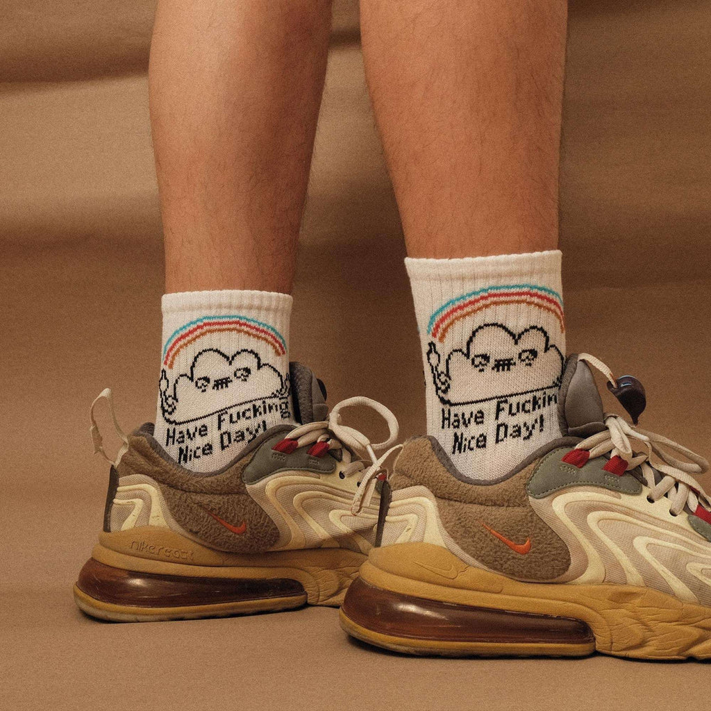White crew socks with rainbow band at cuff and 'Have Fucking Nice Day' cartoon face print