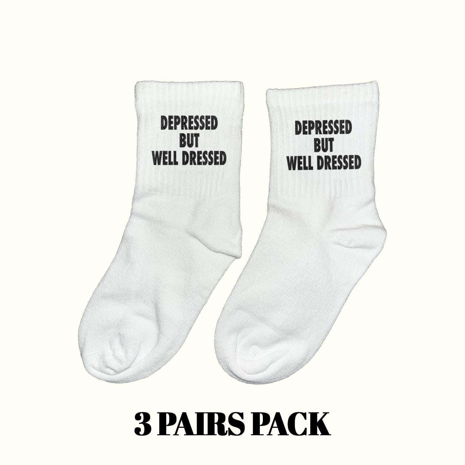 White crew socks with black 'DEPRESSED BUT WELL DRESSED' text, 3-pack