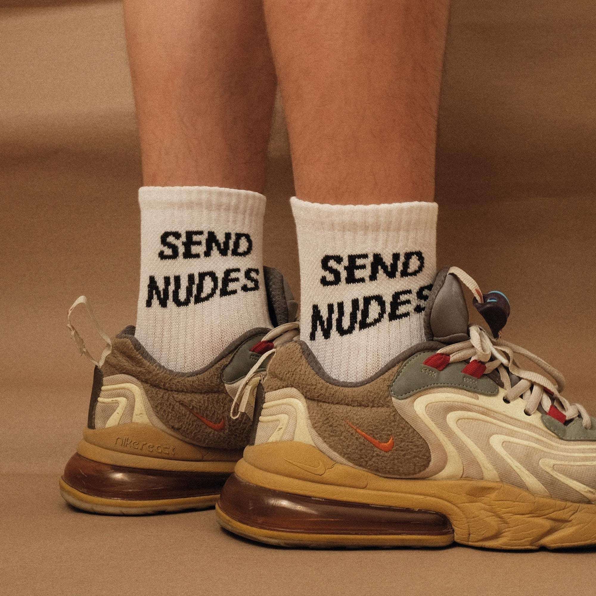 White crew socks with 'SEND NUDES' lettering, ribbed knit cuff