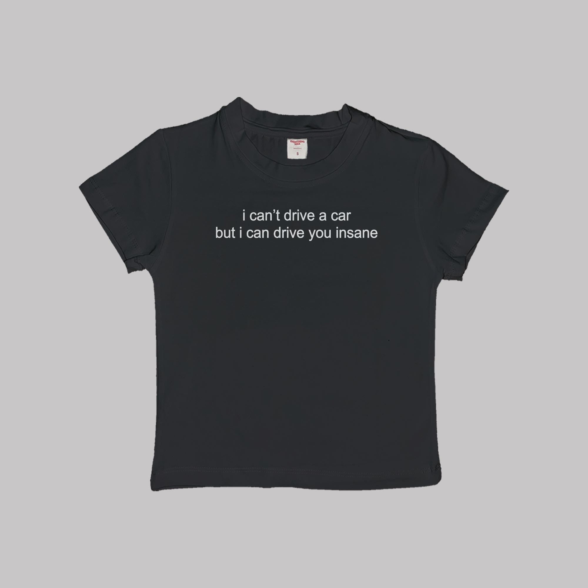Black crop baby tee with white slogan text on the front