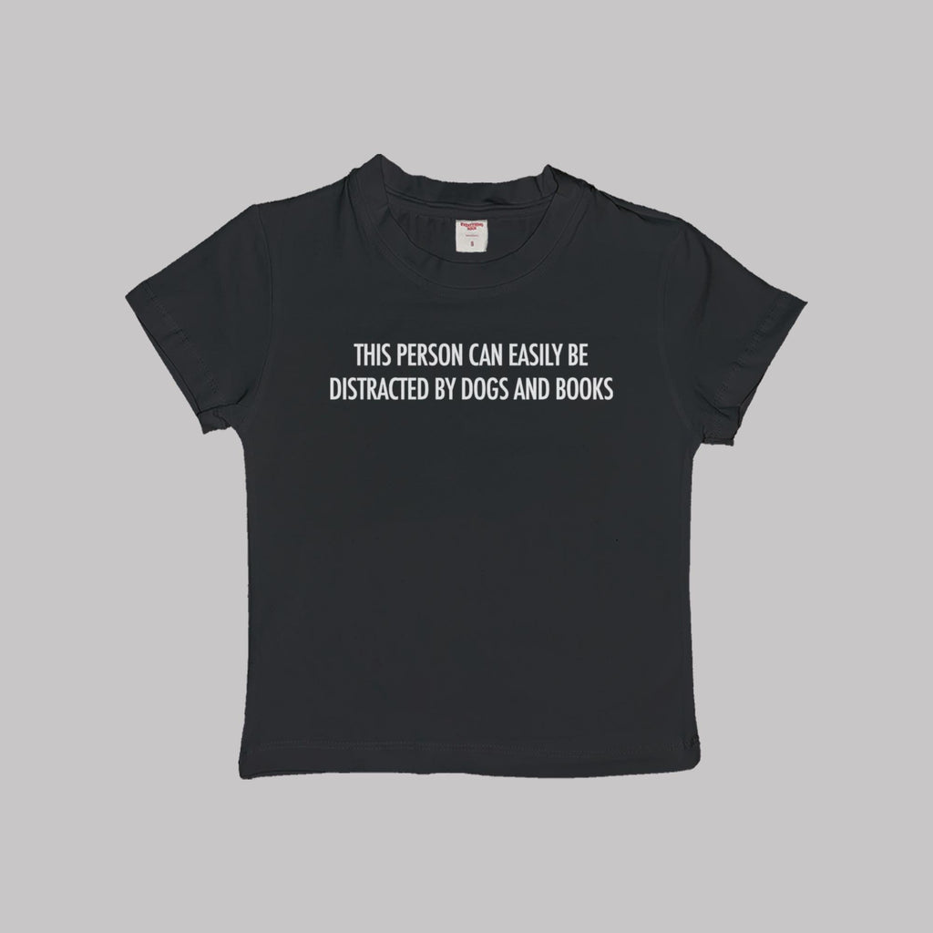 Black baby T-shirt with centered “Dogs and books” slogan