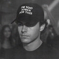 Black baseball cap with white text logo on front