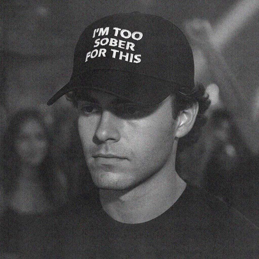Black baseball cap with white text logo on front