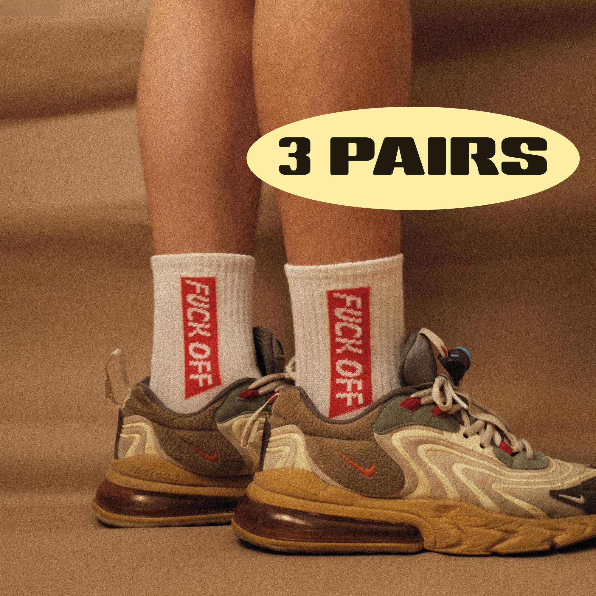 White crew socks with red printed lettering, worn with sneakers