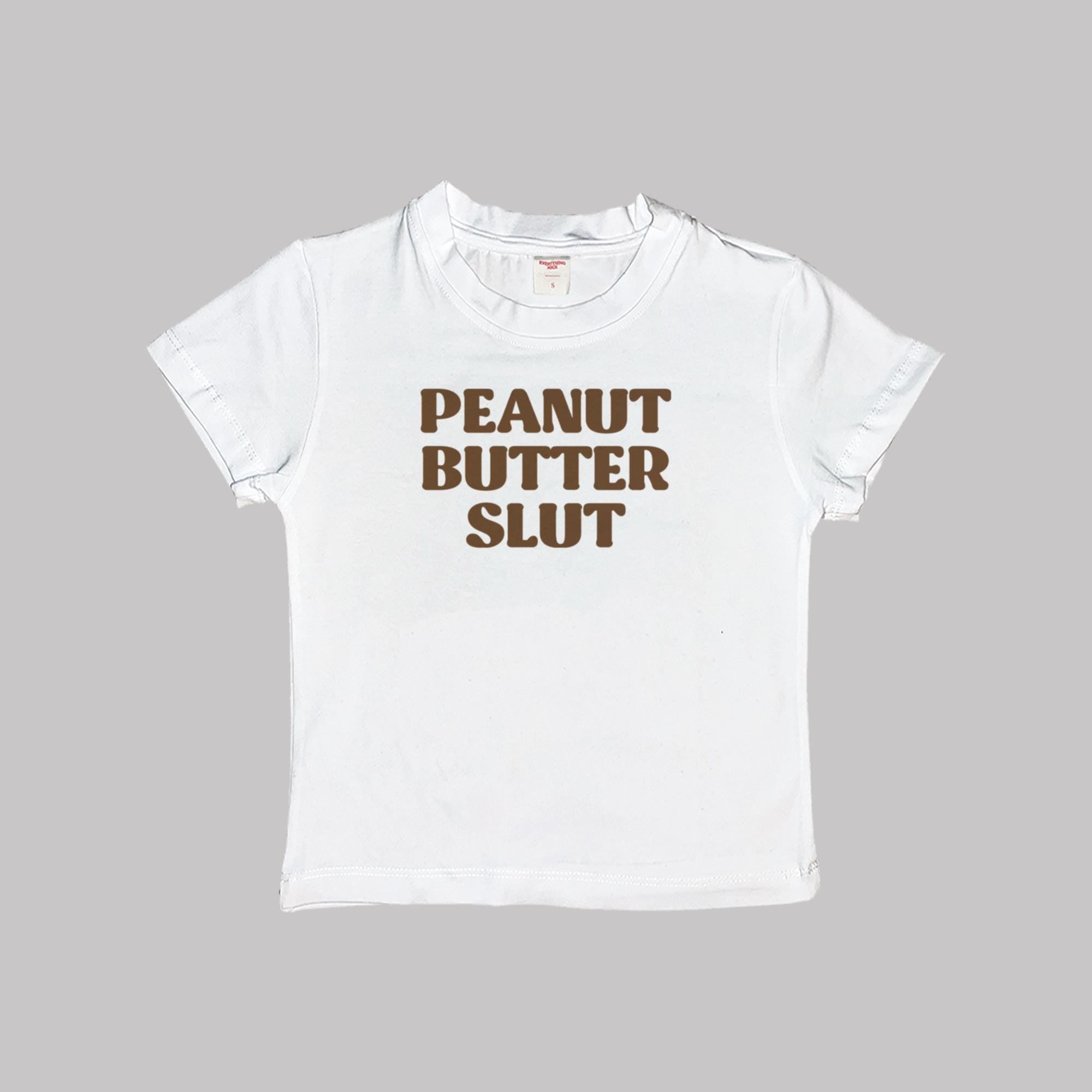 White baby tee crop top with “PEANUT BUTTER SLUT” front graphic