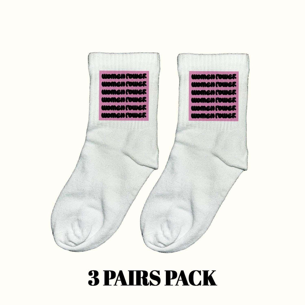 White crew socks with purple empowerment text, cushioned heel and toe