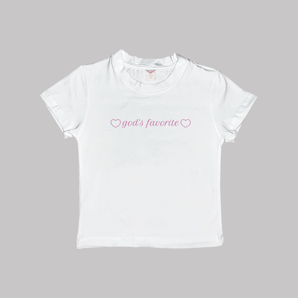 White crop baby tee with "god's favorite" heart logo on chest