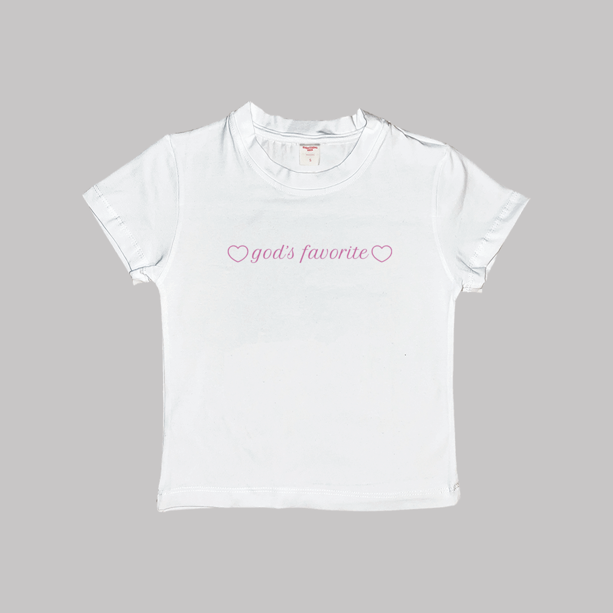 White crop baby tee with "god's favorite" heart logo on chest
