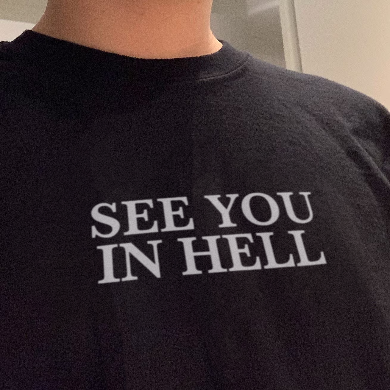 Black graphic T-shirt with 'SEE YOU IN HELL' chest print