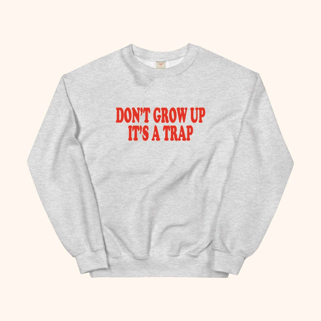 Gray sweatshirt with red "DON'T GROW UP ITS A TRAP" graphic
