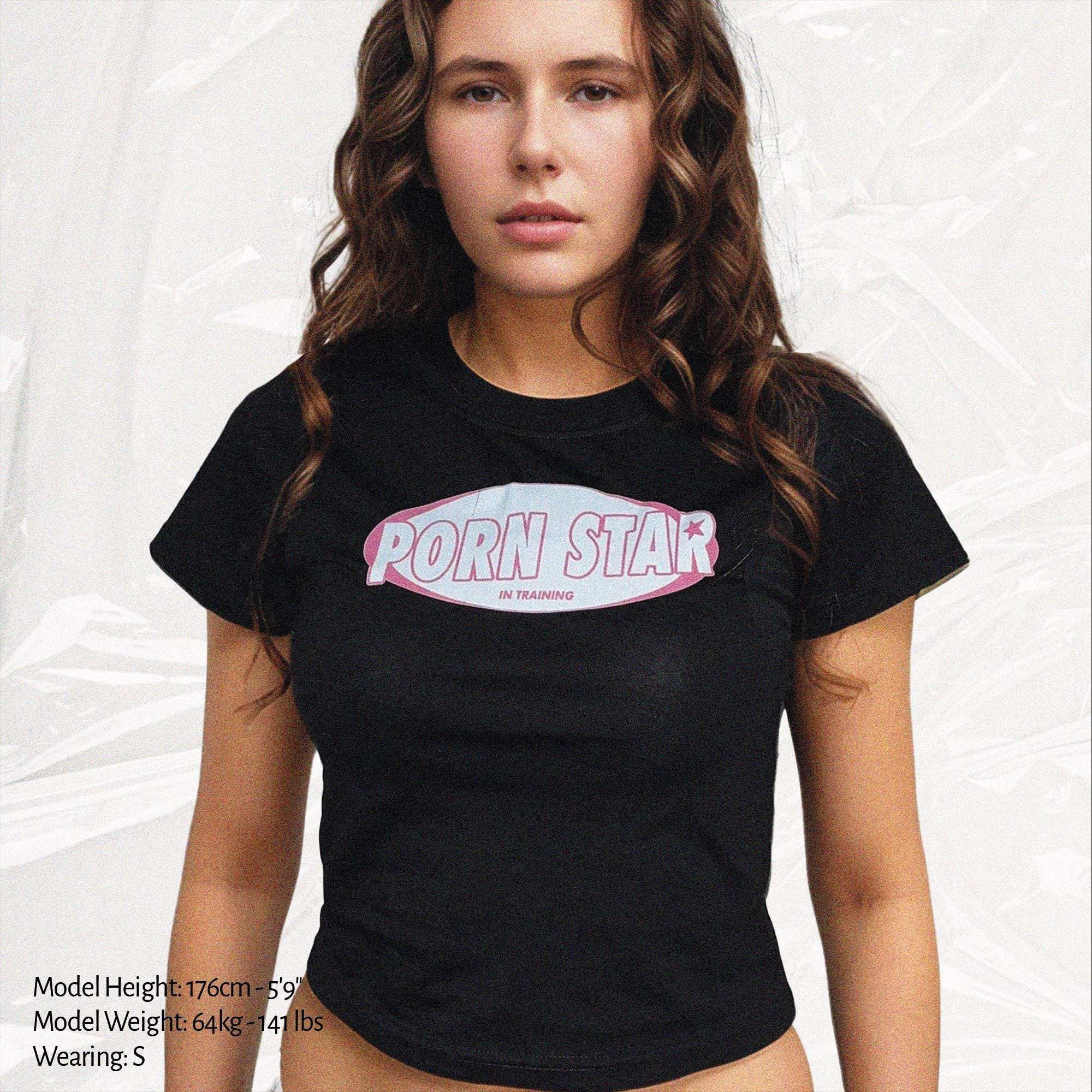 Black baby tee crop top with star training logo graphic, crew neckline