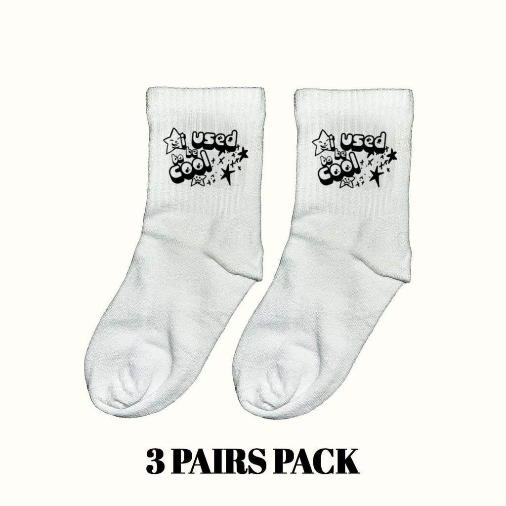 Light gray crew socks with 'Used be Cool' star cartoon print, pair