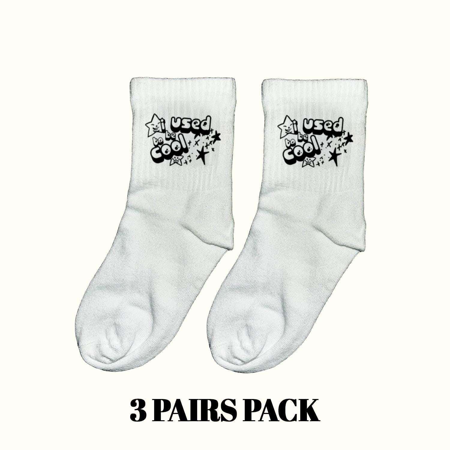 Light gray crew socks with 'Used be Cool' star cartoon print, pair