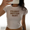 White crop baby tee, “PEANUT BUTTER SLUT” print on chest