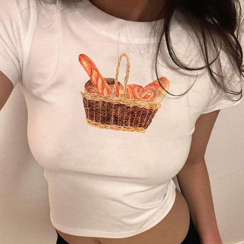 White crop baby tee with woven basket and carrot graphic on front