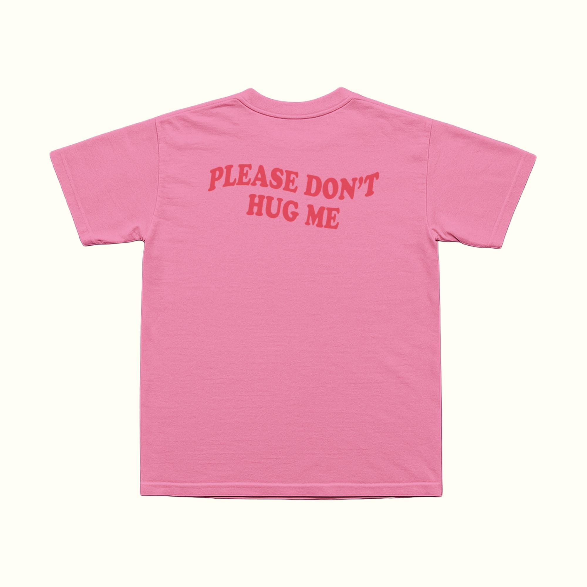 Pink T-shirt back with red 'PLEASE DON'T HUG ME' text