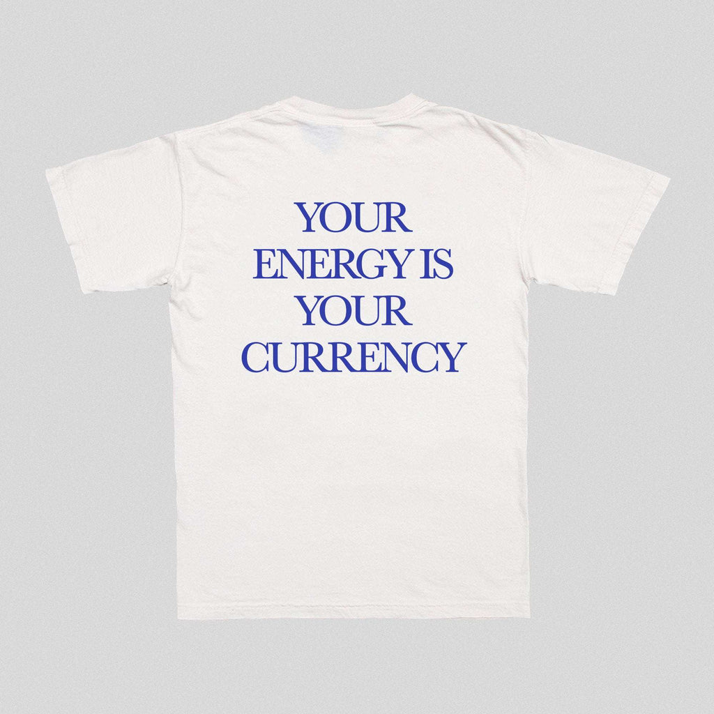 White front T-shirt with blue text “YOUR ENERGY IS YOUR CURRENCY”.