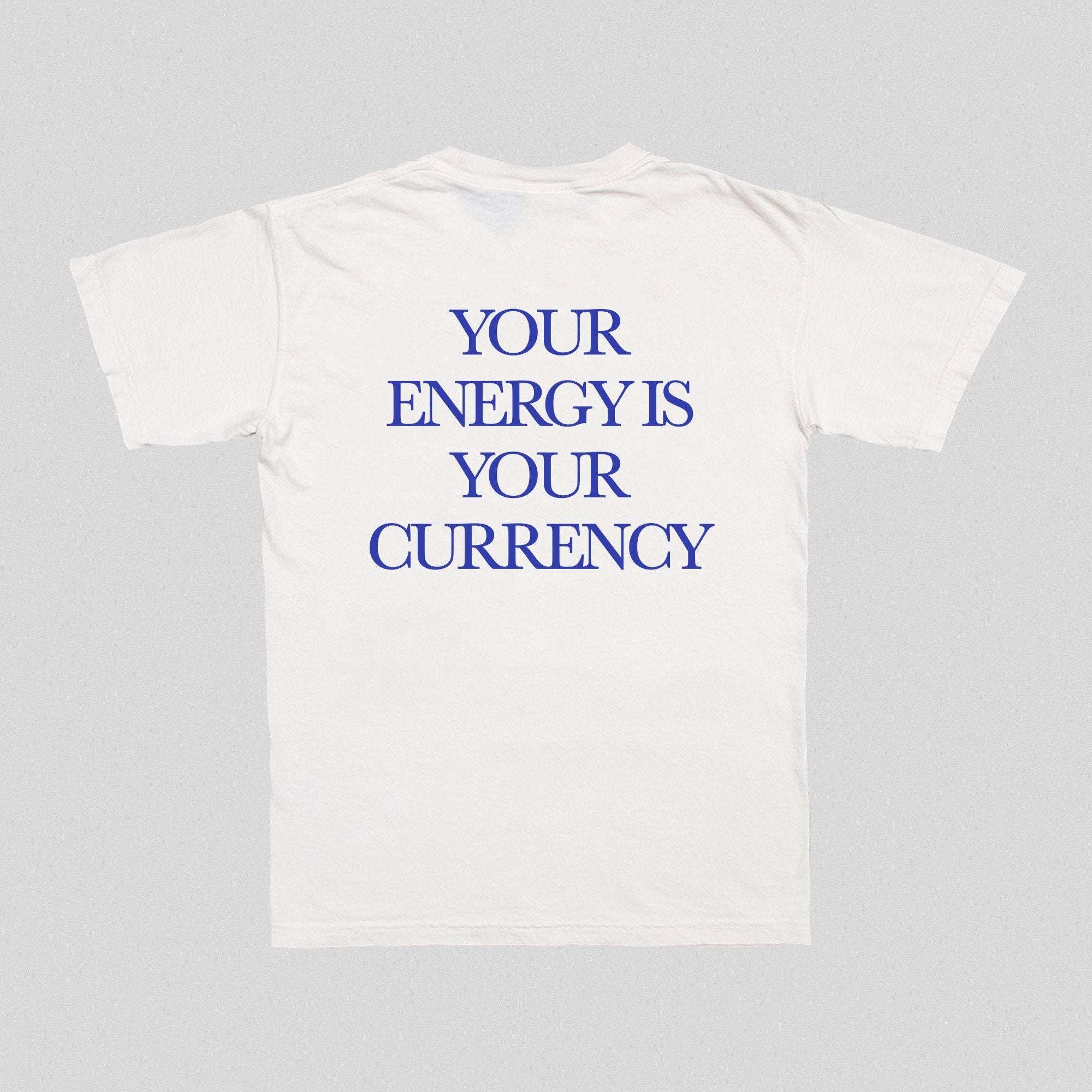 White front T-shirt with blue text “YOUR ENERGY IS YOUR CURRENCY”.