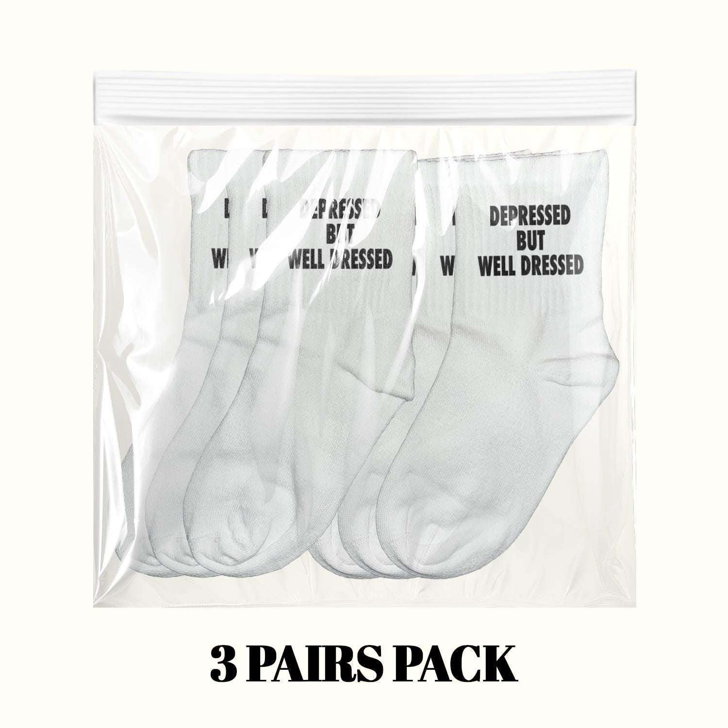 3-pack of white crew socks in clear bag, black 'DEPRESSED BUT WELL DRESSED' text