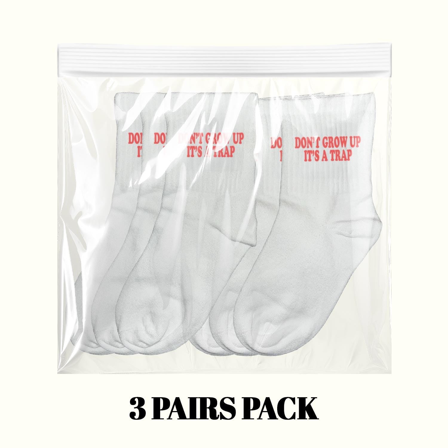 3-pair pack of white crew socks with red 'DON'T GROW UP IT'S A TRAP' print