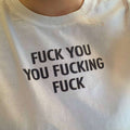 White T-shirt with bold black graphic text on the front