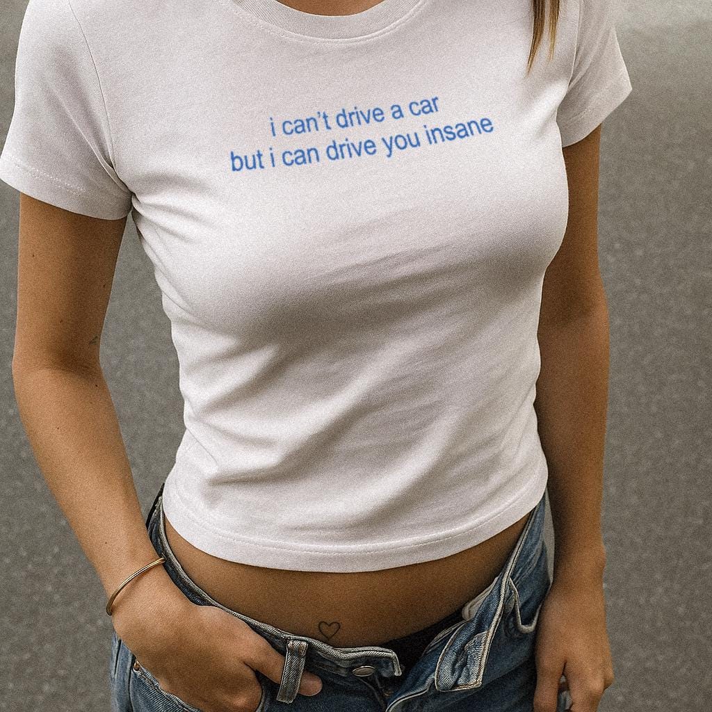White baby tee crop top with blue slogan text on the front