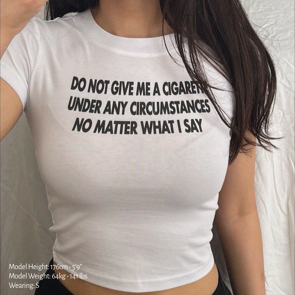 White baby tee crop top with bold black slogan text on the chest