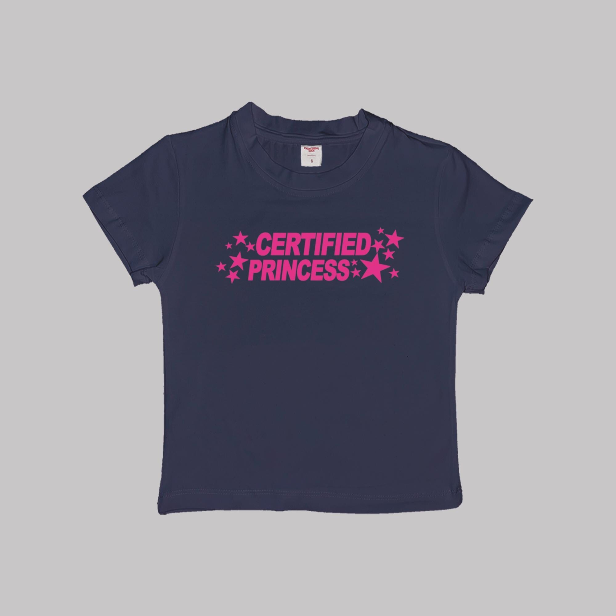 Navy blue short-sleeve crop baby tee with pink 'CERTIFIED PRINCESS' star text.