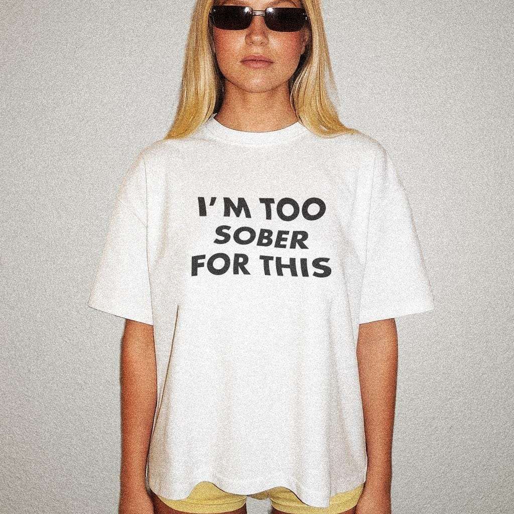White unisex T-shirt with bold text graphic “I’m too sober for this”