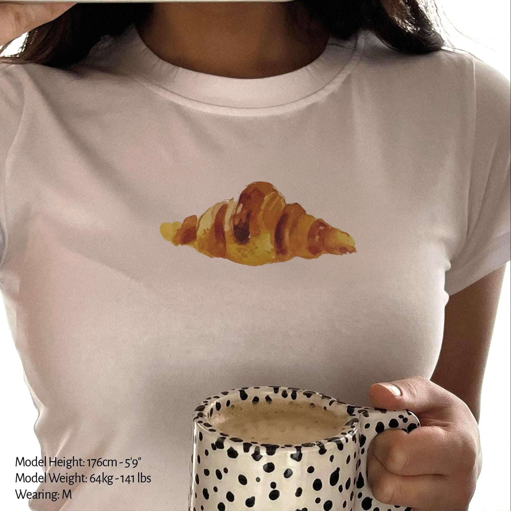 White baby tee crop top with watercolor croissant graphic on front