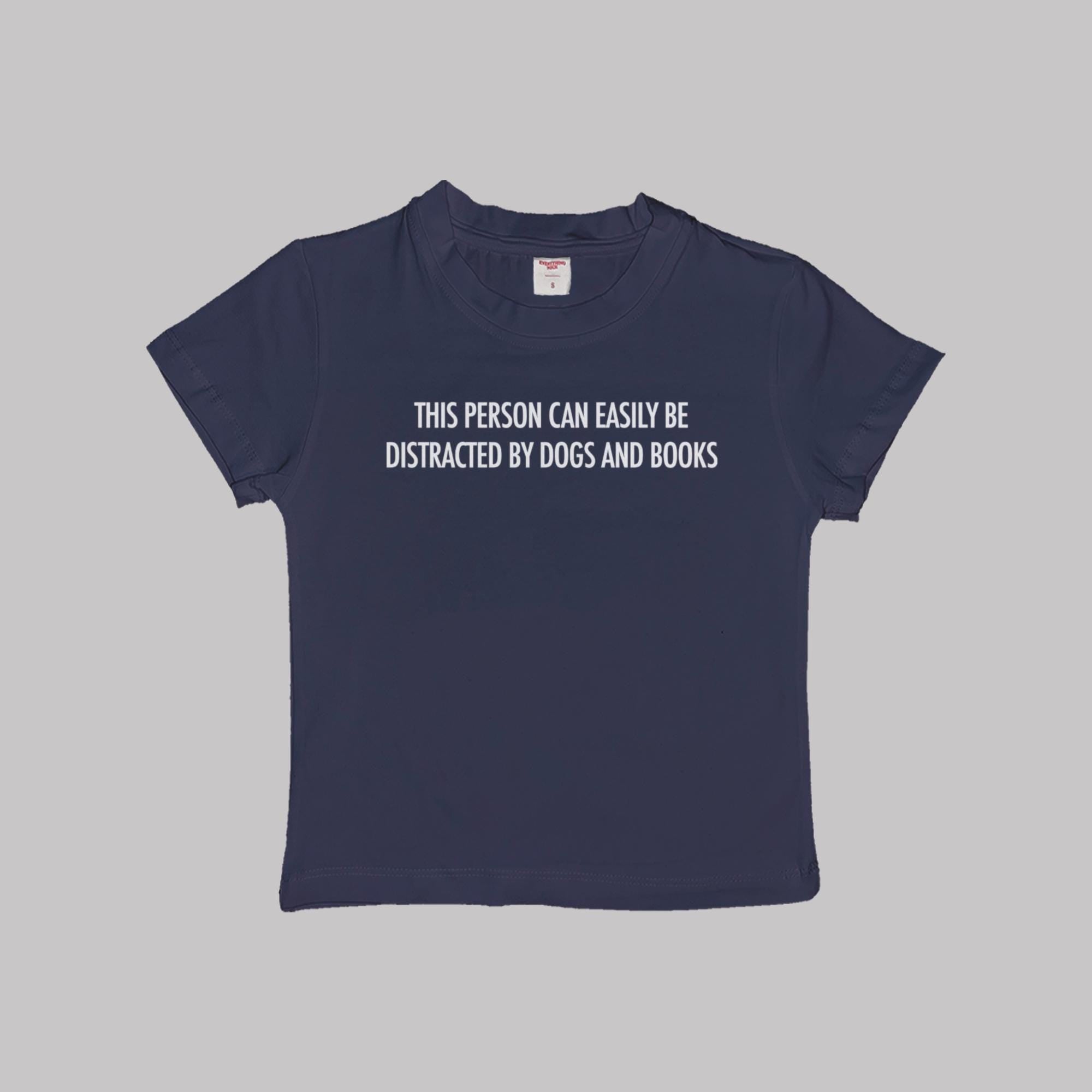 Navy blue baby T-shirt with “Dogs and books” slogan on the front