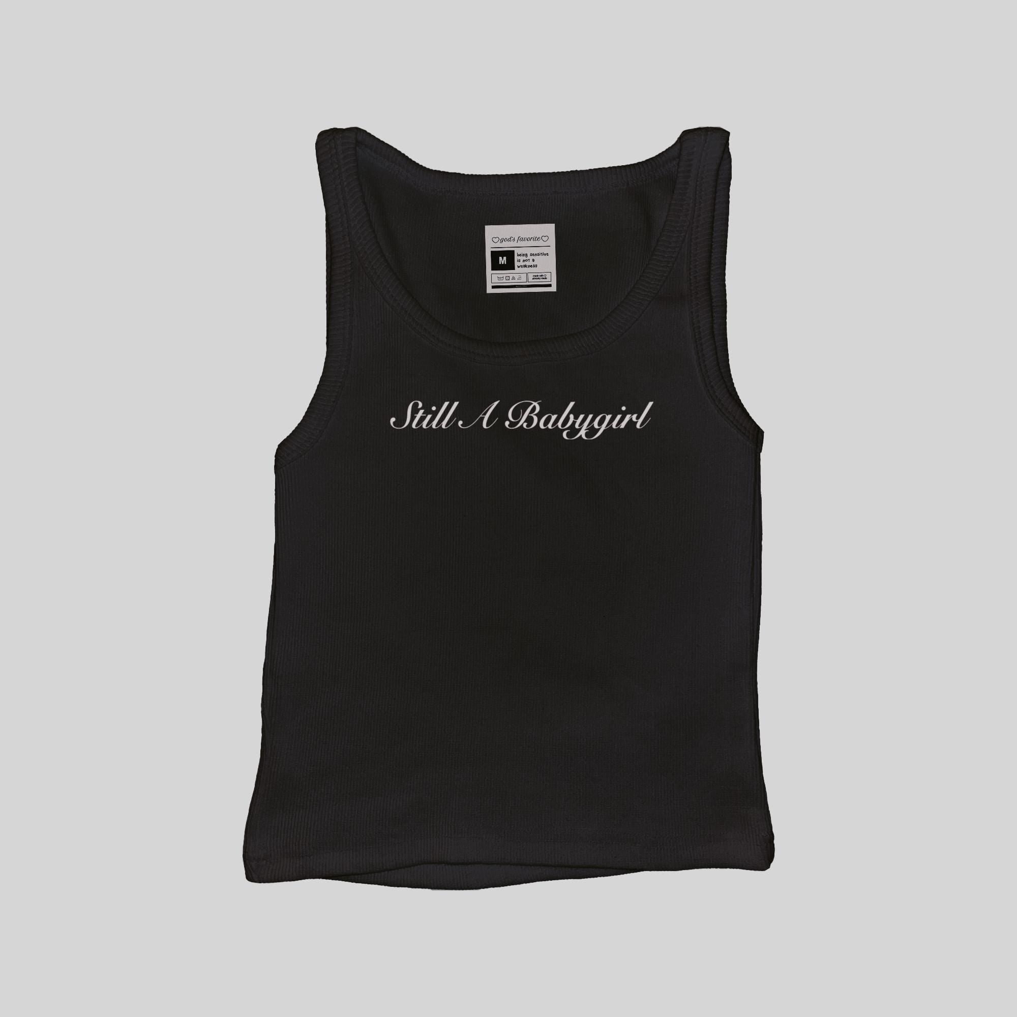 Black ribbed muscle tank top with 'Still A Babygirl' script on the chest