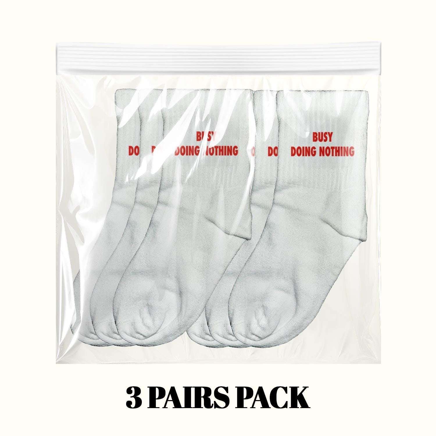3-pack light gray crew socks with red "Busy Doing Nothing" text in plastic bag
