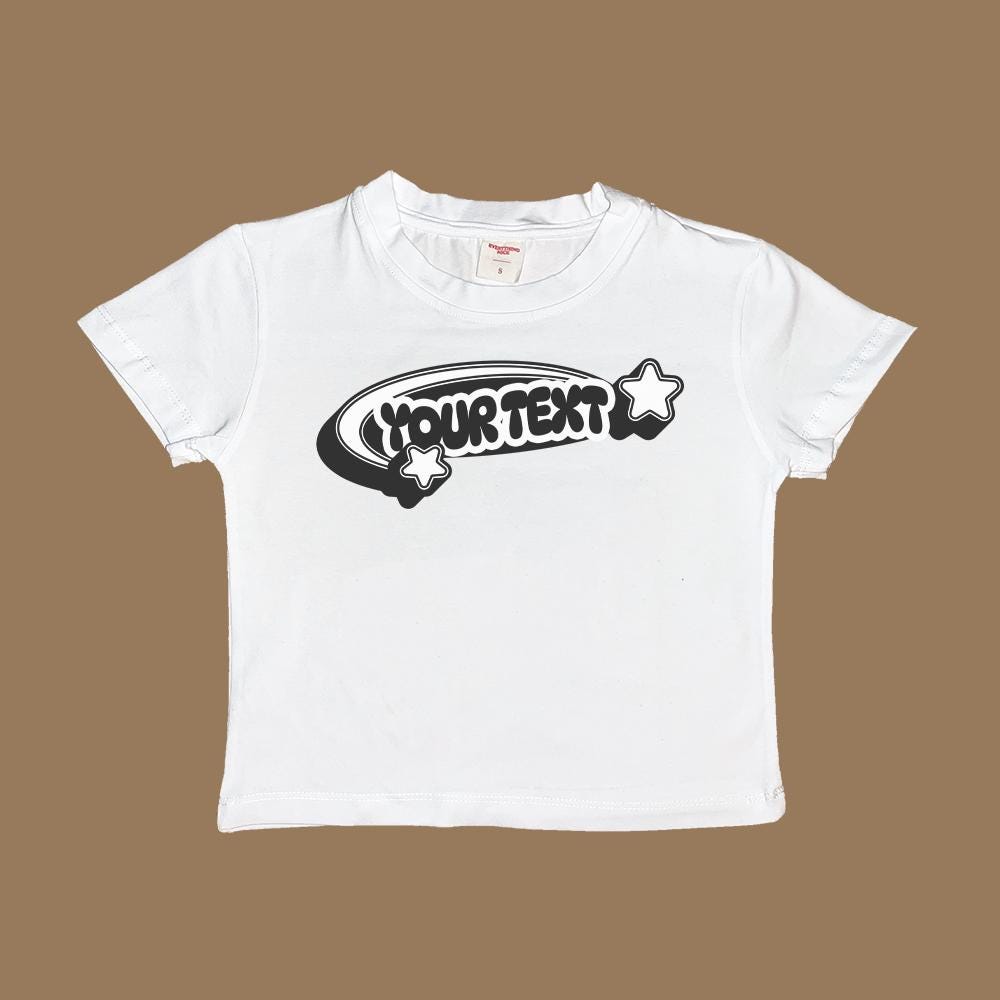 Custom white baby t-shirt with 'YOUR TEXT' graphic and star accents on the front