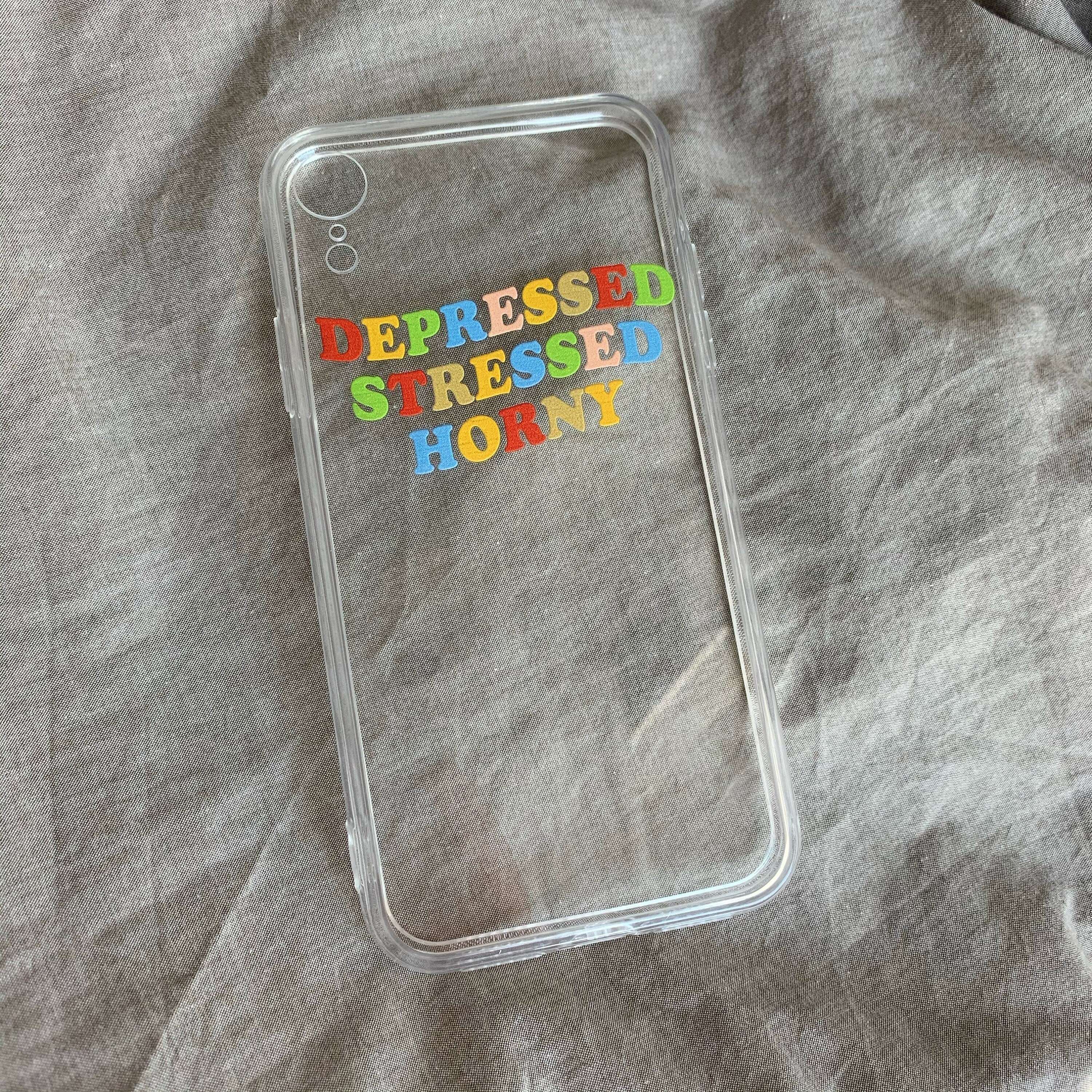 iPhone case with clear backing and colorful 'DEPRESSED STRESSED HORNY' lettering