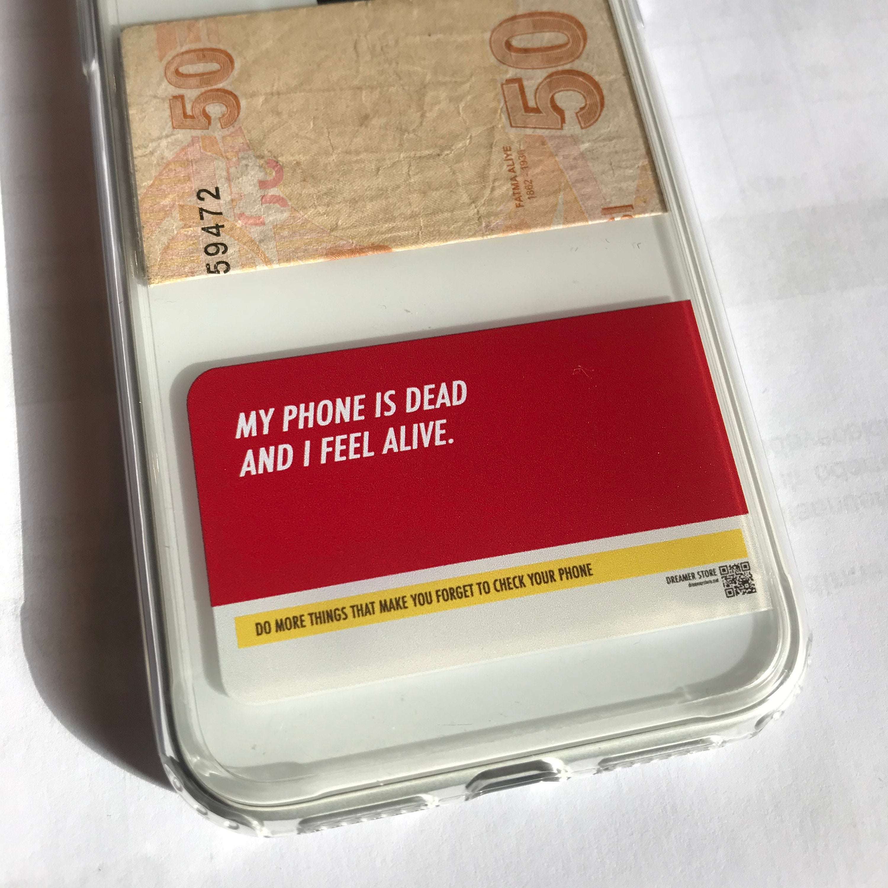 Red iPhone case with white quote text, clear edges, and yellow slogan strip