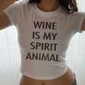 White baby tee crop top with “WINE IS MY SPIRIT ANIMAL” print in brown text.